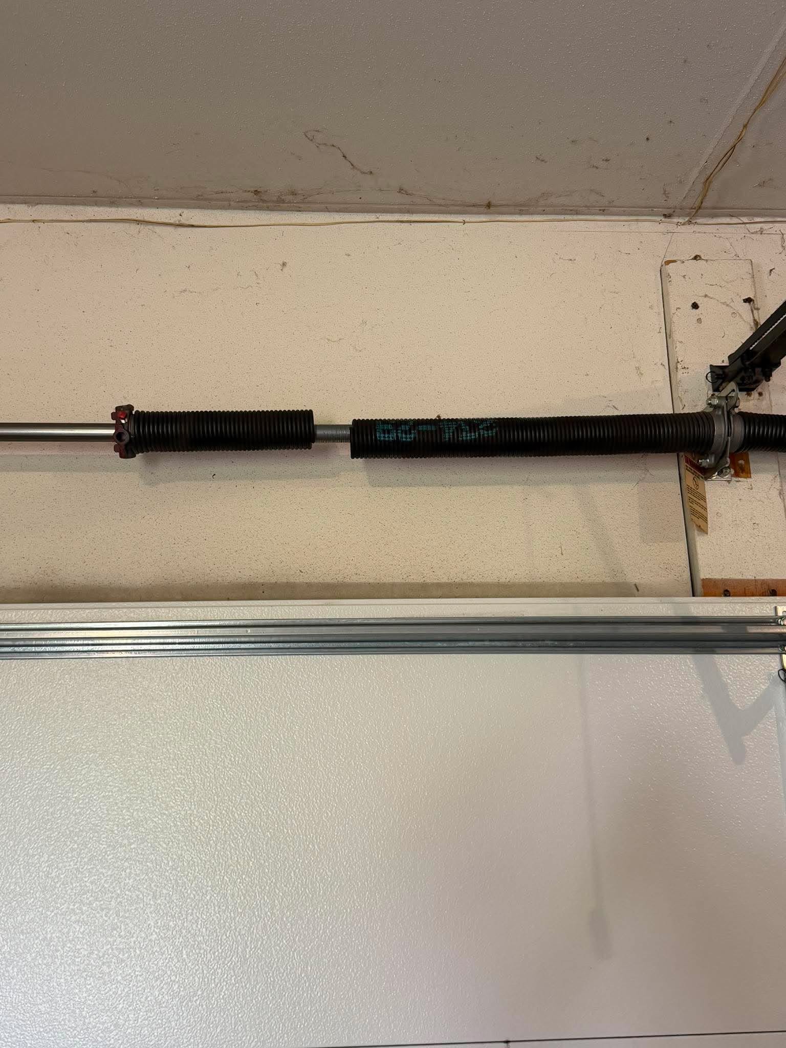 Broken residential garage door torsion spring