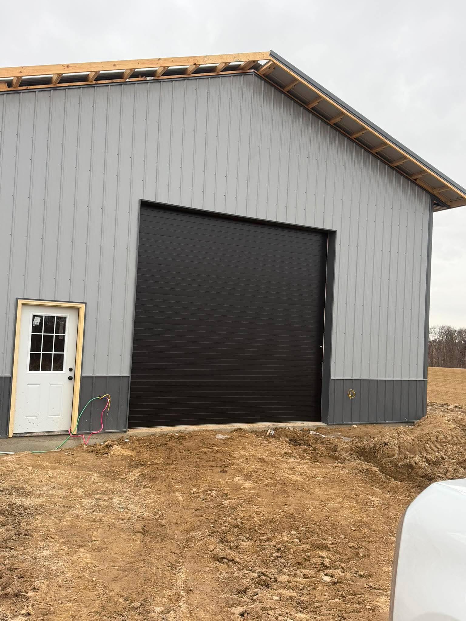14 by 14 black insulated garage door on steel building